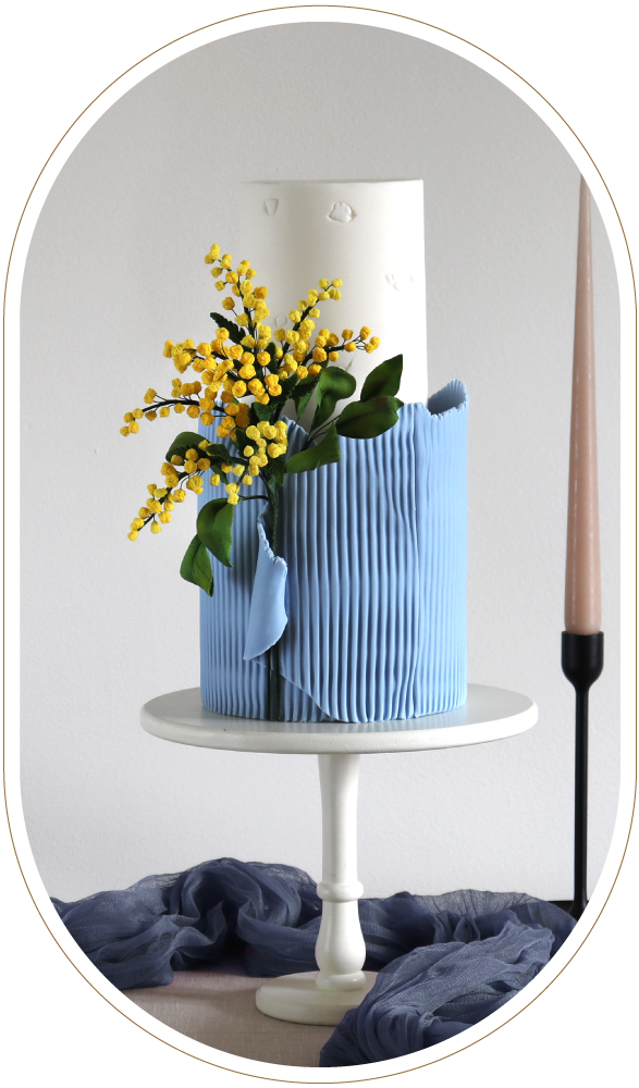 Fine art powder blue 2 tier wedding cake with hand made sugar mimosa.